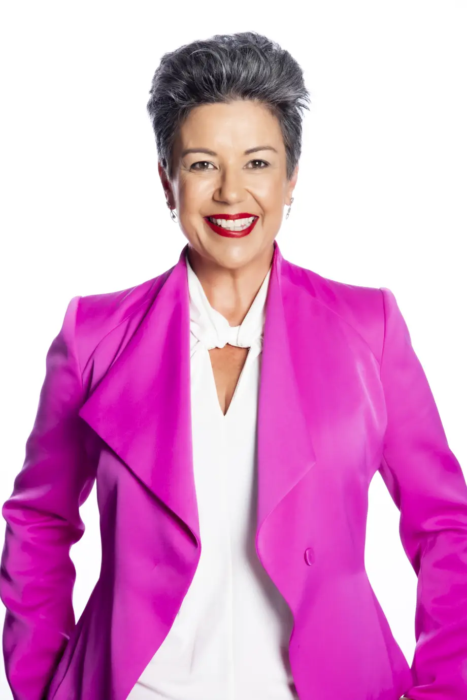 Paula Bennett smiles widely - she is wearing a vibrant coloured blazer..