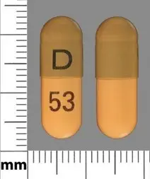 two capsules, half yellow, half dark grey/yellow. One side of the capsule shows "D 53", they are about 20mm long.. 